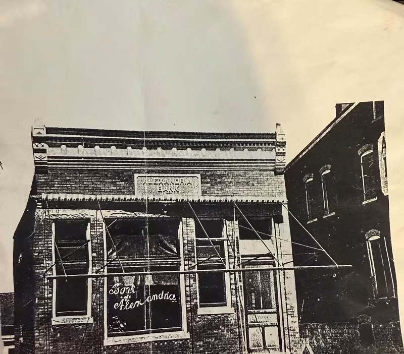 Historic photograph of the Bank of Alexandria building, with awnings over its front windows